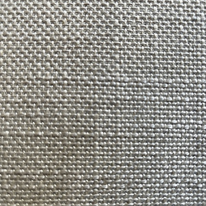 Close-up of a textured, beige woven fabric showing a grid-like pattern created by interlacing threads. The surface appears slightly rough, with visible fibers and small gaps between the threads.