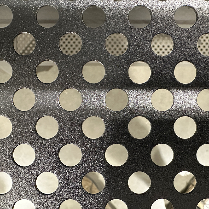 Close-up of a metallic surface with evenly spaced round holes arranged in rows, showing a blurred background through the holes. The surface has a slight wave or bend running horizontally.