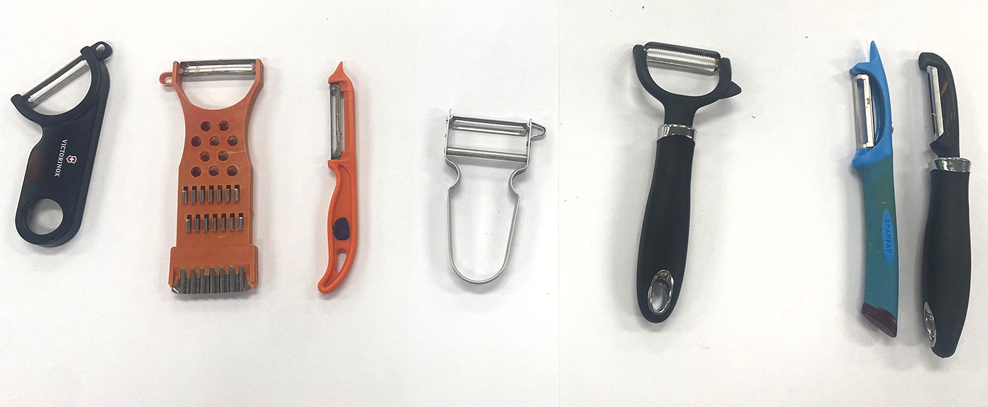 Six different types of vegetable peelers are arranged side by side on a white surface, showcasing various shapes, sizes, and handle designs.