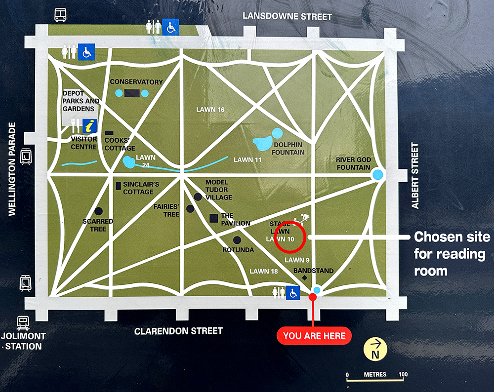 Map of a park with paths, lawns, gardens, and landmarks. “You Are Here” marker is at the bottom near the Bandstand. A red circle highlights the chosen site for a reading room at Lawn 10, close to the center-right.